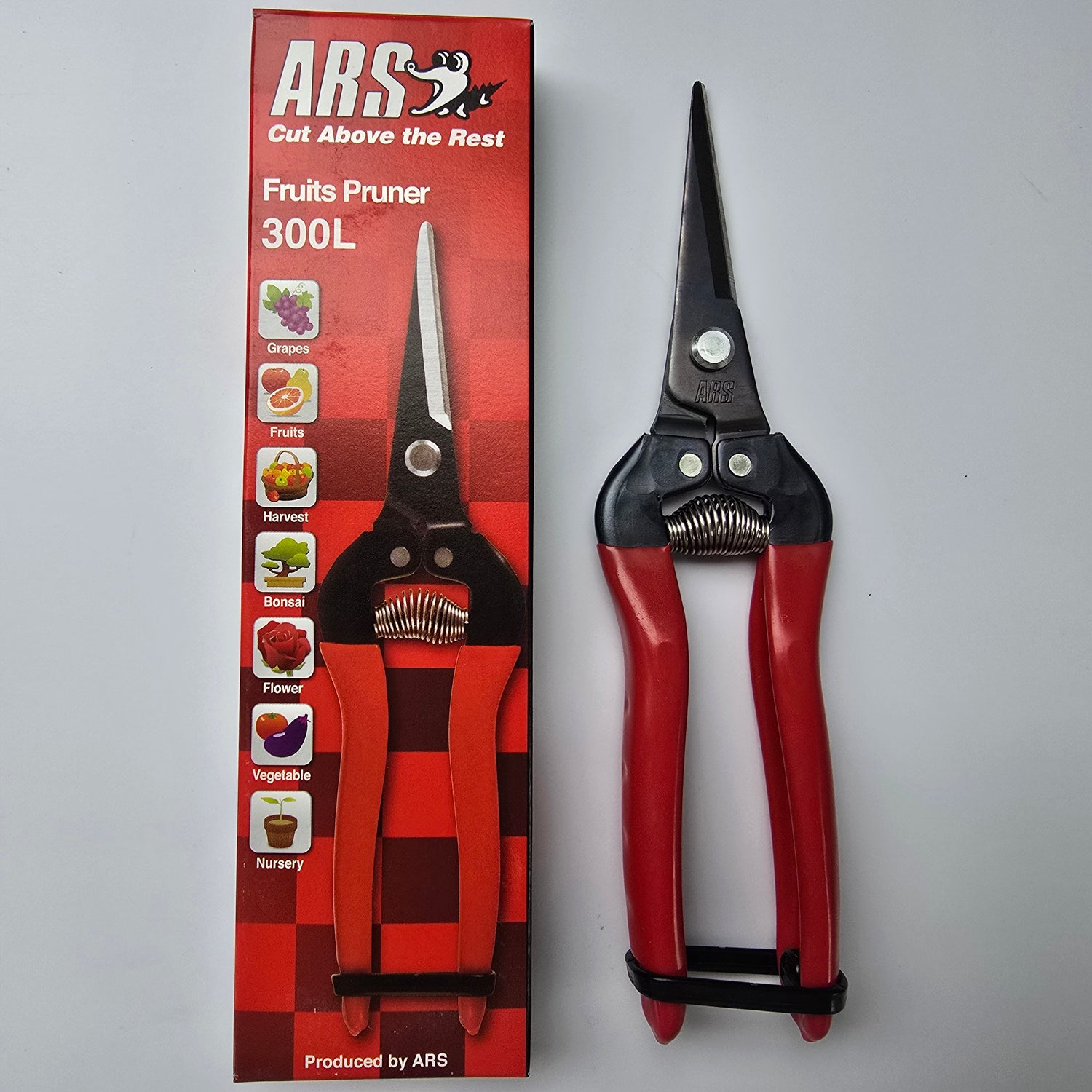 Fruits pruner with red handles next to its packaging on a gray background