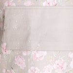 Floral patterned fabric with pink flowers on a light background